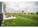 Spacious backyard with lush green grass, patio, and black iron fence for outdoor enjoyment at 505 Shallowroot Ln, Sheridan, IN 46069