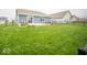 Enjoy the expansive fenced backyard featuring a patio area, lush grass, and beautiful landscaping at 505 Shallowroot Ln, Sheridan, IN 46069