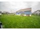 Well-maintained backyard featuring a large lawn, patio area, and partial fence at 505 Shallowroot Ln, Sheridan, IN 46069