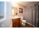 Functional bathroom with a shower-tub combo, single sink vanity, and dark wood grain floor at 505 Shallowroot Ln, Sheridan, IN 46069