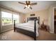 Inviting bedroom with large window, cozy carpet, and a black four poster bed at 505 Shallowroot Ln, Sheridan, IN 46069