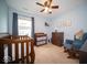 Cozy Bedroom features a crib, changing table, dresser, and comfortable rocking chair in a light-blue room at 505 Shallowroot Ln, Sheridan, IN 46069