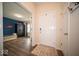 Bright foyer featuring wood floors, and an open doorway to a blue accent wall at 505 Shallowroot Ln, Sheridan, IN 46069