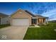 Charming single-story home with brick facade, attached garage, green lawn, and evening sky at 505 Shallowroot Ln, Sheridan, IN 46069