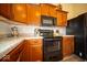 Well-appointed kitchen with warm wood cabinets and stainless steel appliances at 505 Shallowroot Ln, Sheridan, IN 46069
