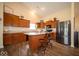Open kitchen with granite countertops, island, stainless steel appliances, and breakfast bar at 505 Shallowroot Ln, Sheridan, IN 46069