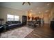 Open-concept living space with hardwood floors, dining area, and modern kitchen with stainless appliances at 505 Shallowroot Ln, Sheridan, IN 46069