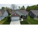 Aerial view of a brick home with well-manicured lawn, and long driveway at 509 Tulip Tree Dr, Lapel, IN 46051