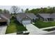 Aerial view of a brick home with well-manicured lawn, and long driveway at 509 Tulip Tree Dr, Lapel, IN 46051