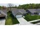 Aerial view of a brick home with well-manicured lawn, and long driveway at 509 Tulip Tree Dr, Lapel, IN 46051