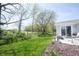 Expansive backyard with lush green grass, patio, and beautiful landscaping at 509 Tulip Tree Dr, Lapel, IN 46051