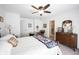 Light-filled bedroom with a ceiling fan, warm lighting, and traditional style decor at 509 Tulip Tree Dr, Lapel, IN 46051