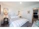 Bright bedroom features neutral paint, ceiling light, a comfortable bed and closet at 509 Tulip Tree Dr, Lapel, IN 46051