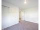 The empty bedroom with white walls and neutral carpet with sliding closet door at 509 Tulip Tree Dr, Lapel, IN 46051