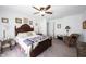 Inviting bedroom features classic wood furnishings, ceiling fan, and plush carpeting at 509 Tulip Tree Dr, Lapel, IN 46051