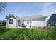 Home exterior showcasing sliding glass door, windows, and patio at 509 Tulip Tree Dr, Lapel, IN 46051