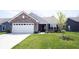 Charming brick home with well-maintained lawn and attached garage at 509 Tulip Tree Dr, Lapel, IN 46051
