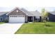 Charming single-story brick home featuring an attached garage and a well-manicured lawn at 509 Tulip Tree Dr, Lapel, IN 46051