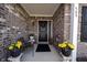 Covered front porch with seating, potted plants, and a decorative wreath on the front door at 509 Tulip Tree Dr, Lapel, IN 46051