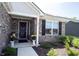 Inviting front porch showcasing brickwork, decorative plants, and a welcoming entrance at 509 Tulip Tree Dr, Lapel, IN 46051