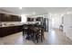 Open kitchen with wooden cabinetry, stainless steel appliances, and dining area at 509 Tulip Tree Dr, Lapel, IN 46051