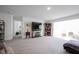 Spacious living room with a stone fireplace, built-in shelving, and neutral carpet at 509 Tulip Tree Dr, Lapel, IN 46051