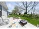 Inviting patio with outdoor seating, fire pit, and view of lush green lawn at 509 Tulip Tree Dr, Lapel, IN 46051