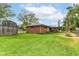 Backyard featuring a brick home and a shed with a well maintained lawn at 5101 Dickson Rd, Indianapolis, IN 46226