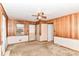 Bedroom with wood paneling, carpet, window with blinds, ceiling fan, and closet at 5101 Dickson Rd, Indianapolis, IN 46226