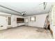Cluttered garage with a workbench and a garage door opener at 5101 Dickson Rd, Indianapolis, IN 46226