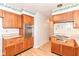 Bright kitchen featuring wood cabinets, laminate countertops, and stainless steel appliances at 5101 Dickson Rd, Indianapolis, IN 46226