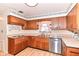 This kitchen features wooden cabinets, light countertops, and a stainless steel dishwasher at 5101 Dickson Rd, Indianapolis, IN 46226