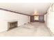 Living room with fireplace, neutral carpet, floral border, and wallpapered accent wall at 5101 Dickson Rd, Indianapolis, IN 46226