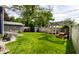 Wide backyard with a pergola, swing, picnic table set, shed, and plenty of green grass at 5241 Guilford Ave, Indianapolis, IN 46220