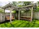 Charming backyard pergola with a swing and a picnic table set, great for relaxing outdoors at 5241 Guilford Ave, Indianapolis, IN 46220