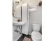 Efficient bathroom featuring black hex tile floors, modern fixtures, and built-in storage at 5241 Guilford Ave, Indianapolis, IN 46220