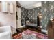 Unique Bedroom design with patterned wallpaper, black crib, and hardwood floors at 5241 Guilford Ave, Indianapolis, IN 46220