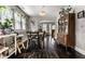 Charming dining room showcasing hardwood floors, vintage cabinet, and bright windows with natural accents at 5241 Guilford Ave, Indianapolis, IN 46220
