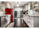 Bright, galley kitchen with stainless steel appliances, white cabinetry, and a retro red refrigerator at 5241 Guilford Ave, Indianapolis, IN 46220