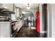 Well-lit kitchen leading to the dining area, with white cabinets, stainless steel appliances, and a retro red refrigerator at 5241 Guilford Ave, Indianapolis, IN 46220