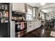 Modern kitchen featuring white cabinets, stainless steel appliances, tile backsplash, and view to the dining room at 5241 Guilford Ave, Indianapolis, IN 46220
