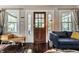 Cozy living room featuring hardwood floors, a comfortable blue sofa, and a stylish entryway at 5241 Guilford Ave, Indianapolis, IN 46220