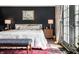 Cozy main bedroom features a king bed, dark accent wall, a decorative rug, and French doors at 5241 Guilford Ave, Indianapolis, IN 46220