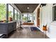 Bright sunroom featuring neutral furniture, plants, and natural light at 5241 Guilford Ave, Indianapolis, IN 46220