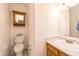 Bright half bathroom features a toilet, vanity and sink, with a medicine cabinet for additional storage at 5351 Eel River Ct, Indianapolis, IN 46221