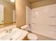 A bathroom featuring a toilet, bathtub with showerhead, and vanity with sink and storage at 5351 Eel River Ct, Indianapolis, IN 46221
