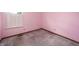 Cozy pink bedroom featuring a window with plantation shutters and plush carpeting at 5351 Eel River Ct, Indianapolis, IN 46221