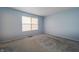 A simple bedroom featuring plush carpeting and a bright window at 5351 Eel River Ct, Indianapolis, IN 46221