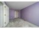 Purple bedroom with neutral carpeting and an open closet offers a comfortable space at 5351 Eel River Ct, Indianapolis, IN 46221