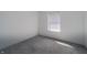 Bright bedroom features neutral walls, carpeting, and a window with blinds for ample natural light at 5351 Eel River Ct, Indianapolis, IN 46221
